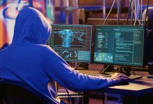 Hooded spy in underground hideout trying to steal valuable data by targeting governmental websites with weak security. Espionage specialist doing cyber attacks to gain access to sensitive info