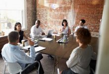 Group Of Businesspeople Meeting for collaboration In Modern Boardroom