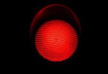 shutterstock 740169646 red light red traffic light against a black background