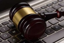 A photograph of a gavel lying sideways on a keyboard.